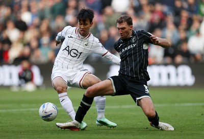 101026 - Swansea City v Norwich City - SkyBet Championship - Eom Ji-Sung of Swansea is tackled by Jack Stacey of Norwich 