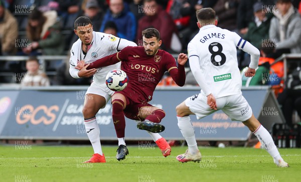 101222 - Swansea City v Norwich City, Sky Bet Championship - Joel Latibeaudiere of Swansea City tangles with Danel Sinani of Norwich City as they compete for the ball