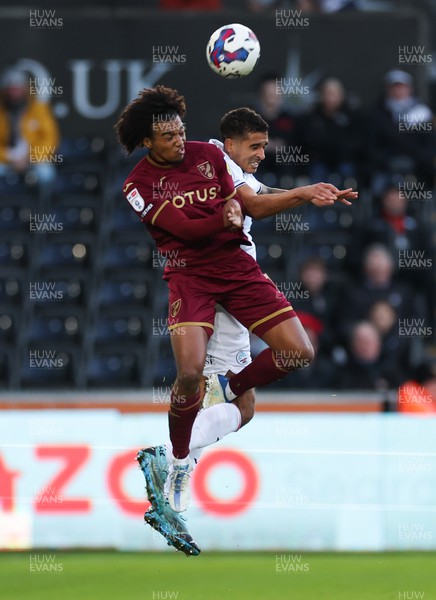 101222 - Swansea City v Norwich City, Sky Bet Championship - Sam McCallum of Norwich City and Kyle Naughton of Swansea City compete for the ball