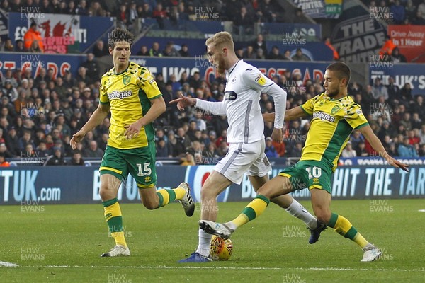 241118 - Swansea City v Norwich City, EFL Championship - Oliver McBurnie of Swansea City (centre) is brought down by Moritz Leitner of Norwich City on the edge of the penalty area
