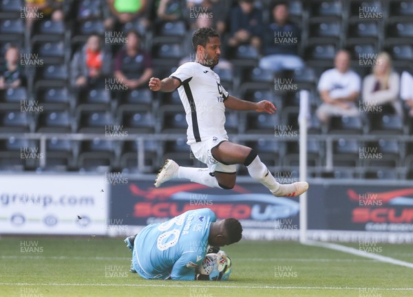 140919 - Swansea City v Nottingham Forest, SkyBet Championship - Wayne Routledge of Swansea City clears Nottingham Forest goalkeeper Brice Samba as he claims the ball