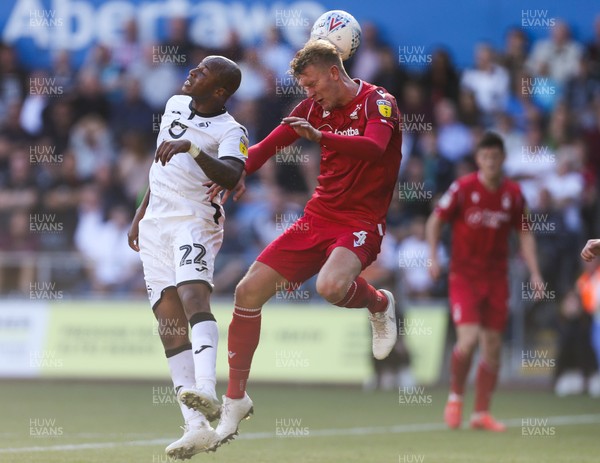 140919 - Swansea City v Nottingham Forest, SkyBet Championship - Andre Ayew of Swansea City and Joe Worrall of Nottingham Forest compete for the ball