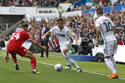 150918- Swansea City v Nottingham Forest, EFL Championship - Declan John of Swansea City (centre) takes on Matty Cash of Nottingham Forest (left)