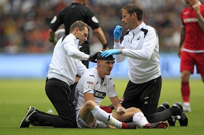 150918- Swansea City v Nottingham Forest, EFL Championship - Jay Fulton of Swansea City receives treatment following a clash of heads