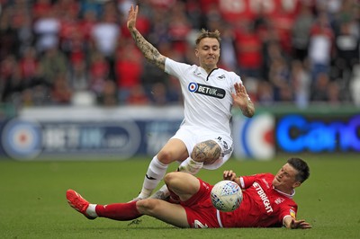 150918- Swansea City v Nottingham Forest, EFL Championship - Barrie McKay of Swansea City (left) is brought down by Joe Lolley of Nottingham Forest