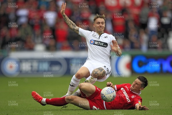 150918- Swansea City v Nottingham Forest, EFL Championship - Barrie McKay of Swansea City (left) is brought down by Joe Lolley of Nottingham Forest