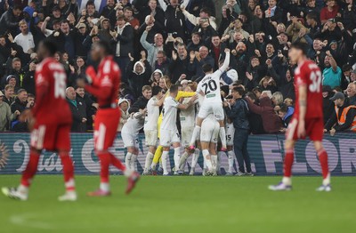 170925 - Swansea City v Nottingham Forest - Carabao Cup - Cameron Burgess of Swansea City and team mates celebrate with fans after he scored their winning goal
