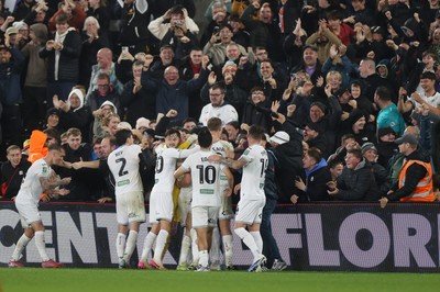 170925 - Swansea City v Nottingham Forest - Carabao Cup - Cameron Burgess of Swansea City and team mates celebrate with fans after he scored their winning goal
