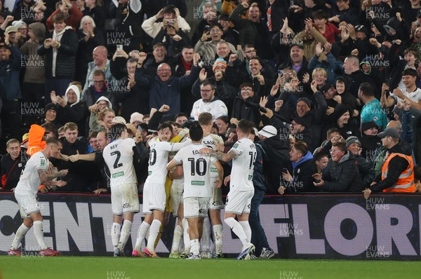 170925 - Swansea City v Nottingham Forest - Carabao Cup - Cameron Burgess of Swansea City and team mates celebrate with fans after he scored their winning goal