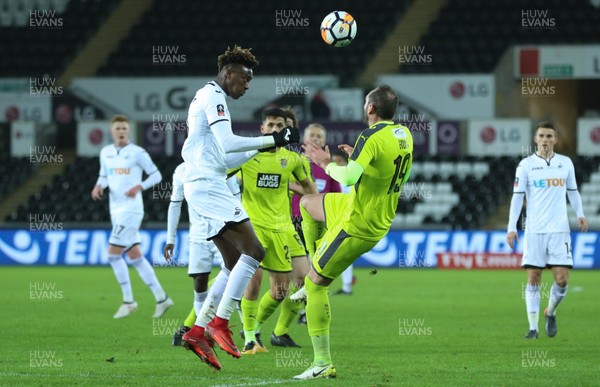 060218 - Swansea City v Notts County, FA Cup Round 4 Replay - Tammy Abraham of Swansea City heads the ball past Nicky Hunt of Notts County
