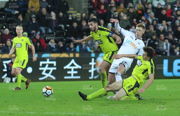 060218 - Swansea City v Notts County, FA Cup Round 4 Replay - Sam Clucas of Swansea City is denied a shot at goal as he is tackled by Matty Virtue of Notts County and Richard Duffy of Notts County