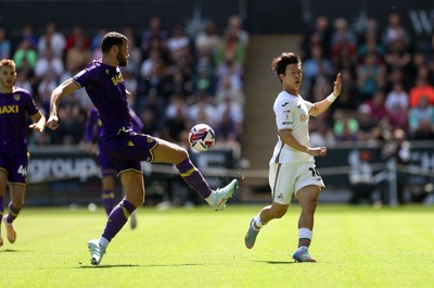 030525 - Swansea City v Oxford United - SkyBet Championship - Eom Ji-Sung of Swansea City is challenged by Elliott Moore of Oxford United 