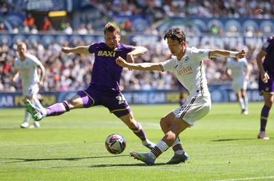 030525 - Swansea City v Oxford United - SkyBet Championship - Eom Ji-Sung of Swansea City is tackled by Hidde ter Avest of Oxford United 