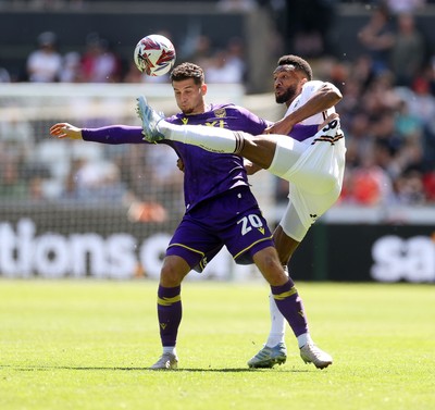 030525 - Swansea City v Oxford United - SkyBet Championship - Ruben Rodrigues of Oxford United is tackled by Hannes Delcroix of Swansea City 