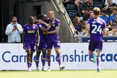 030525 - Swansea City v Oxford United - SkyBet Championship - Greg Leigh of Oxford United celebrates scoring a goal with team mates