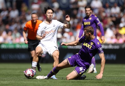 030525 - Swansea City v Oxford United - SkyBet Championship - Eom Ji-Sung of Swansea City is tackled by Michac Helik of Oxford United 