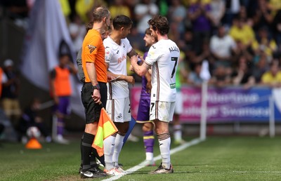 030525 - Swansea City v Oxford United - SkyBet Championship - Joe Allen hands the captains arm band to Kyle Naughton of Swansea City on both players final game