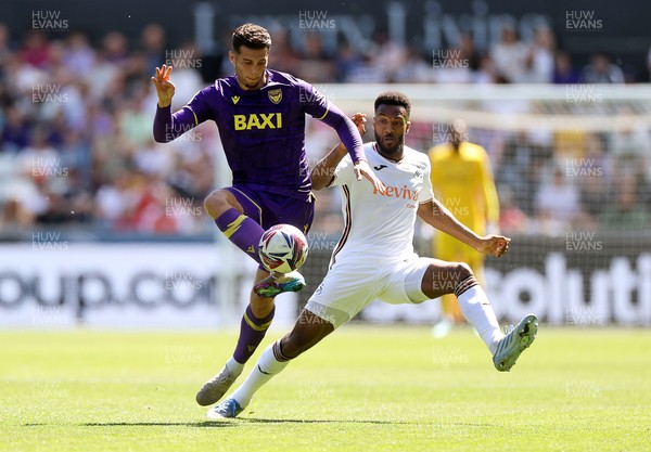 030525 - Swansea City v Oxford United - SkyBet Championship - Ruben Rodrigues of Oxford United is tackled by Hannes Delcroix of Swansea City 