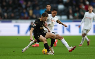 061225 - Swansea City v Oxford United, EFL Sky Bet Championship - Jack Currie of Oxford United is tackled by Ronald of Swansea City