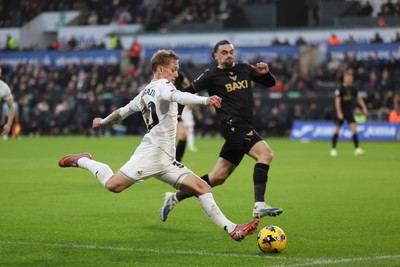 061225 - Swansea City v Oxford United, EFL Sky Bet Championship - Ethan Galbraith of Swansea City crosses as Ciaron Brown of Oxford United closes in