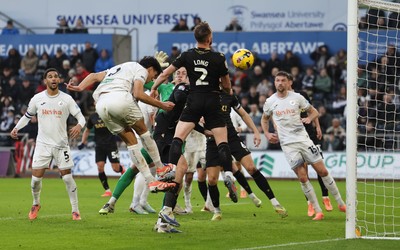 061225 - Swansea City v Oxford United, EFL Sky Bet Championship - Marko Stamenic of Swansea City heads to score the opening goal