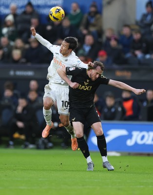 061225 - Swansea City v Oxford United, EFL Sky Bet Championship - Ji-Sung Eom of Swansea City and Sam Long of Oxford United compete for the ball