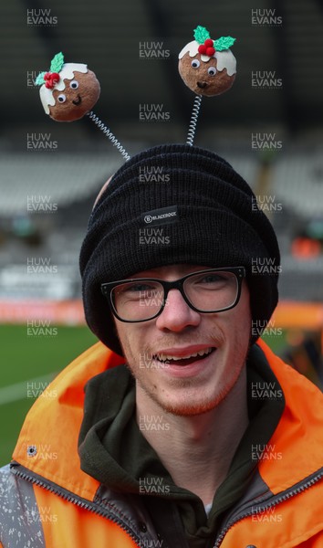 061225 - Swansea City v Oxford United, EFL Sky Bet Championship - Match stewards in the East stand get into the Christmas spirit with festive headwear