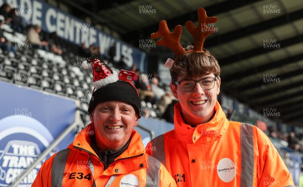 061225 - Swansea City v Oxford United, EFL Sky Bet Championship - Match stewards in the East stand get into the Christmas spirit with festive headwear