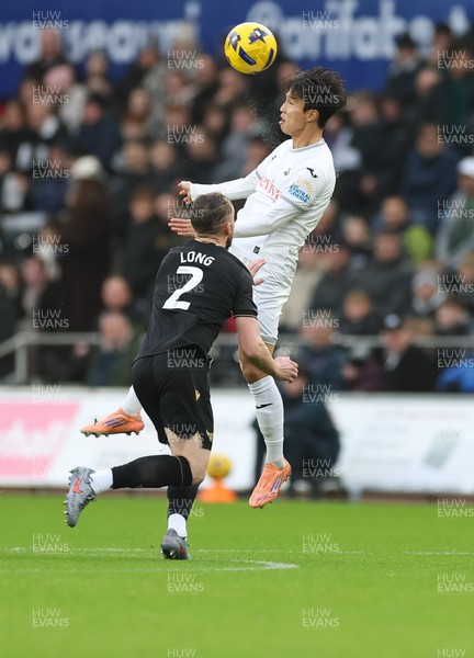 061225 - Swansea City v Oxford United, EFL Sky Bet Championship - Ji-Sung Eom of Swansea City wins the ball from Sam Long of Oxford United