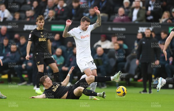 061225 - Swansea City v Oxford United, EFL Sky Bet Championship - Josh Tymon of Swansea City is challenged by Brian De Keersmaecker of Oxford United