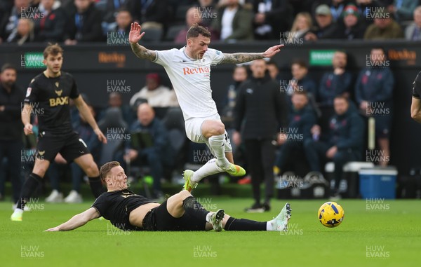 061225 - Swansea City v Oxford United, EFL Sky Bet Championship - Josh Tymon of Swansea City is challenged by Brian De Keersmaecker of Oxford United