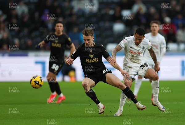 061225 - Swansea City v Oxford United, EFL Sky Bet Championship - Jack Currie of Oxford United is tackled by Ronald of Swansea City