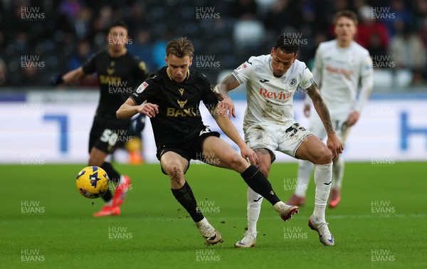 061225 - Swansea City v Oxford United, EFL Sky Bet Championship - Jack Currie of Oxford United is tackled by Ronald of Swansea City