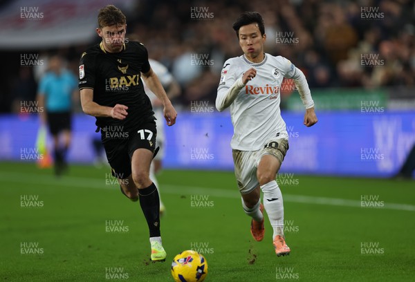061225 - Swansea City v Oxford United, EFL Sky Bet Championship - Stanley Mills of Oxford United and Ji-Sung Eom of Swansea City compete for the ball