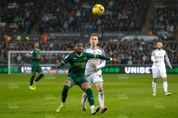 030224 - Swansea City v Plymouth Argyle - Sky Bet Championship - Ollie Cooper of Swansea City and Bali Mumba Of Plymouth Argyle