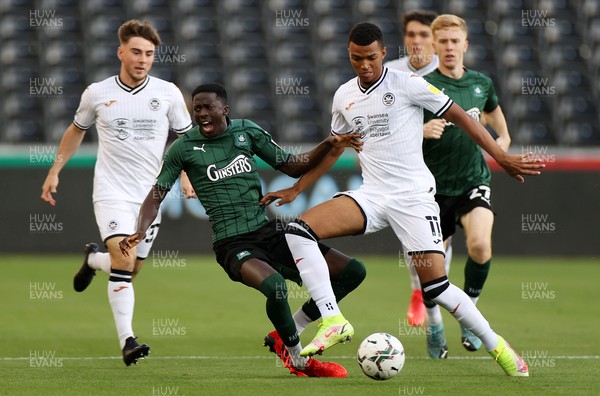 240821 - Swansea City v Plymouth Argyle - Carabao Cup - Morgan Whittaker of Swansea City is challenged by Panutche Camara of Plymouth