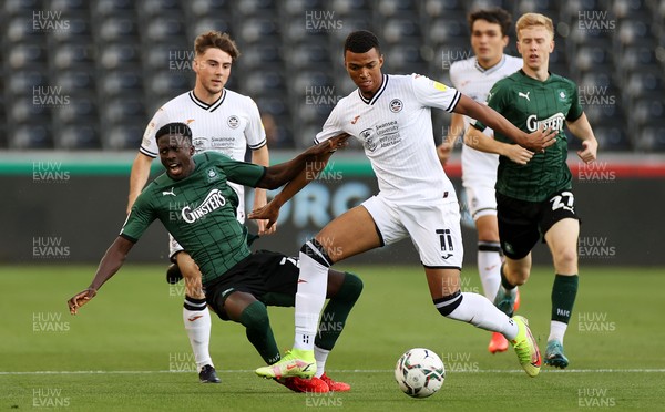 240821 - Swansea City v Plymouth Argyle - Carabao Cup - Morgan Whittaker of Swansea City is challenged by Panutche Camara of Plymouth