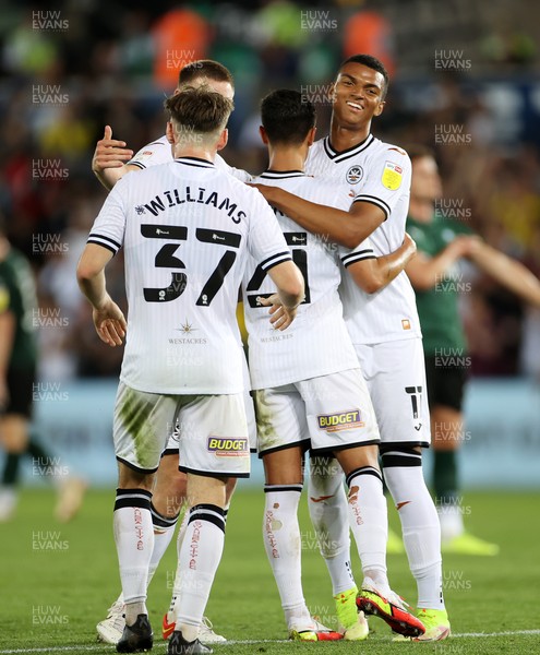 240821 - Swansea City v Plymouth Argyle - Carabao Cup - Morgan Whittaker of Swansea City celebrates scoring a goal with team mates