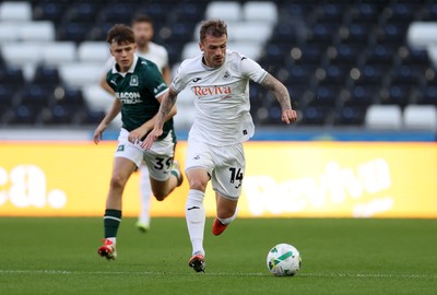 260825 - Swansea City v Plymouth Argyle - Carabao Cup - Josh Tymon of Swansea City gets past Tegan Finn of Plymouth Argyle 