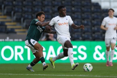 260825 - Swansea City v Plymouth Argyle - Carabao Cup - Zeidane Inoussa of Swansea City is challenged by Matthew Sorinola of Plymouth Argyle 