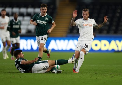 260825 - Swansea City v Plymouth Argyle - Carabao Cup - Josh Tymon of Swansea City is tackled by Joe Edwards of Plymouth Argyle 