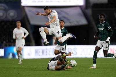 260825 - Swansea City v Plymouth Argyle - Carabao Cup - Zan Vipotnik of Swansea City is tackled by Matthew Sorinola of Plymouth Argyle 