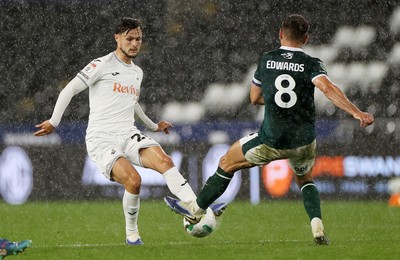 260825 - Swansea City v Plymouth Argyle - Carabao Cup - Liam Cullen of Swansea City is challenged by Joe Edwards of Plymouth Argyle 