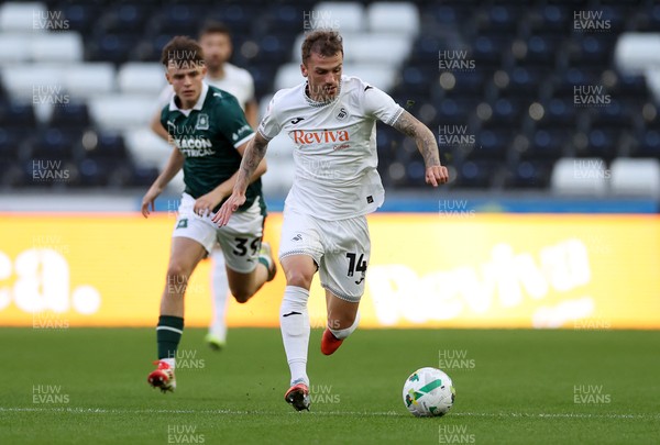 260825 - Swansea City v Plymouth Argyle - Carabao Cup - Josh Tymon of Swansea City gets past Tegan Finn of Plymouth Argyle 
