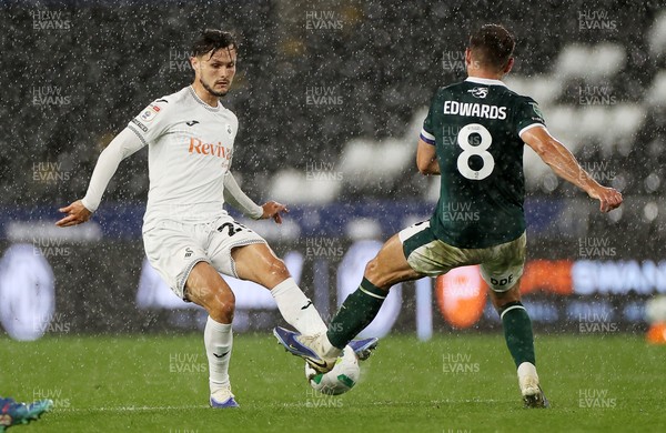 260825 - Swansea City v Plymouth Argyle - Carabao Cup - Liam Cullen of Swansea City is challenged by Joe Edwards of Plymouth Argyle 