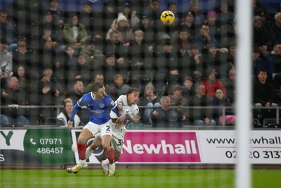 091225 - Swansea City v Portsmouth - Sky Bet Championship - Ronald Pereira Martin of Swansea City and Jordan Williams of Portsmouth compete for the ball