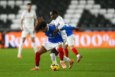 091225 - Swansea City v Portsmouth - Sky Bet Championship - Harvey Blair of Portsmouth and Malick Yalcouyé of Swansea City compete for the ball