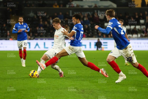 091225 - Swansea City v Portsmouth - Sky Bet Championship - Ethan Galbraith of Swansea City is challenged by Ibane Bowat of Portsmouth