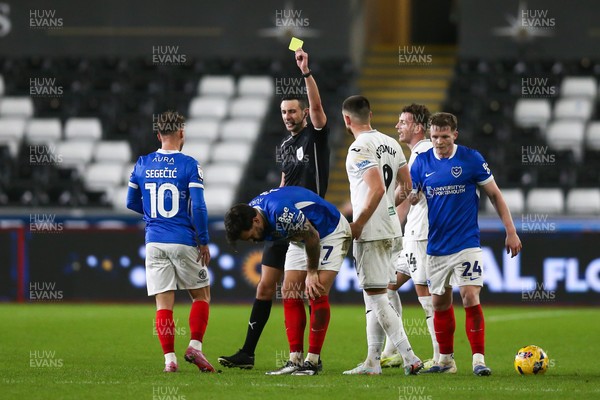 091225 - Swansea City v Portsmouth - Sky Bet Championship - Referee Tom Reeves shows Marlon Pack of Portsmouth a yellow card