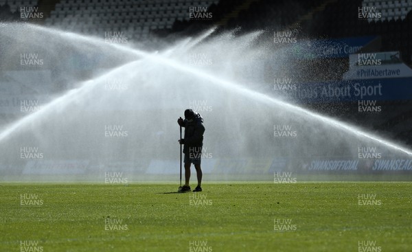 050421 Swansea City v Preston North End, Sky Bet Championship - Ground staff at the Liberty Stadium prepare the pitch as the sprinkler system activates ahead of the match